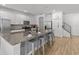 Bright, all white kitchen featuring a large center island with seating and stainless steel appliances at 6012 Oak Green Loop, Davenport, FL 33837