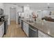 A kitchen featuring a large island with granite countertops and stainless steel appliances at 6012 Oak Green Loop, Davenport, FL 33837