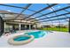 The beautiful screened-in pool with attached hot tub has ample deck space with outdoor seating for relaxing and entertaining at 6012 Oak Green Loop, Davenport, FL 33837