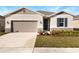 New single-story house with a two-car garage, and neatly landscaped front yard at 914 Heirloom Dr, Haines City, FL 33844