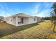 Rear view of house showcasing backyard and patio at 914 Heirloom Dr, Haines City, FL 33844