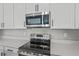 Stainless steel range and microwave in a modern kitchen setting at 914 Heirloom Dr, Haines City, FL 33844