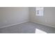 Simple bedroom with gray carpet and window at 918 Heirloom Dr, Haines City, FL 33844