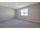 Spacious bedroom with gray carpet and large window at 918 Heirloom Dr, Haines City, FL 33844