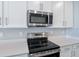 Stainless steel range and microwave in a modern kitchen at 918 Heirloom Dr, Haines City, FL 33844