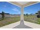 Backyard featuring covered patio area and green space at 1635 Sugarbelle Cir, Mascotte, FL 34753