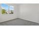 Clean, carpeted bedroom with a large window offering plenty of natural light and views of the outdoors at 1635 Sugarbelle Cir, Mascotte, FL 34753