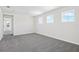Bedroom featuring gray carpet, fresh paint, and three windows for plenty of light at 1635 Sugarbelle Cir, Mascotte, FL 34753