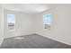 Bedroom features neutral paint, carpet and two windows that provide natural light at 1635 Sugarbelle Cir, Mascotte, FL 34753