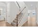 Inviting hallway with a staircase, tiled flooring, and views into adjacent rooms at 1635 Sugarbelle Cir, Mascotte, FL 34753
