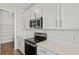 Close-up of a kitchen featuring modern appliances, white cabinets, and sleek countertops at 1635 Sugarbelle Cir, Mascotte, FL 34753