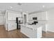 Modern kitchen with a center island, stainless steel appliances, and ample white cabinetry at 1635 Sugarbelle Cir, Mascotte, FL 34753