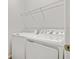 Laundry room featuring modern washer and dryer and a wire rack shelf above at 1635 Sugarbelle Cir, Mascotte, FL 34753