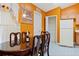 Cozy dining area with wood table and chairs, adjacent to kitchen at 2419 Willow Tree Ln, Kissimmee, FL 34758