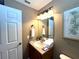 Bathroom with vanity, sink, and mirror at 3189 Yellow Lantana Ln, Kissimmee, FL 34747