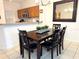 Kitchen dining area with wooden table and four chairs at 3189 Yellow Lantana Ln, Kissimmee, FL 34747