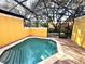 Octagonal pool with covered patio and landscaping at 3189 Yellow Lantana Ln, Kissimmee, FL 34747