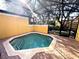 Octagonal pool with covered patio and landscaping at 3189 Yellow Lantana Ln, Kissimmee, FL 34747