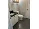 Clean bathroom with dark tile floor and white vanity at 11460 Chateaubriand Ave, Orlando, FL 32836