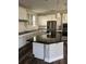 Modern kitchen with center island, stainless steel appliances, and dark countertops at 11460 Chateaubriand Ave, Orlando, FL 32836