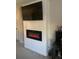 Comfortable living room featuring a modern fireplace, large TV, and neutral wall color at 2867 Matera Dr, St Cloud, FL 34771