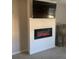 Cozy living room featuring a modern fireplace, large TV, and neutral wall color at 2867 Matera Dr, St Cloud, FL 34771