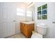 Clean bathroom with wood vanity, toilet, and a decorative tile accent wall at 8545 Bay Lilly Loop, Kissimmee, FL 34747