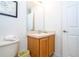 Simple bathroom with wood vanity and toilet at 8545 Bay Lilly Loop, Kissimmee, FL 34747