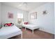 Bedroom with two twin beds, nightstands, and cheerful decor at 8545 Bay Lilly Loop, Kissimmee, FL 34747