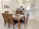 Dining area with wood table and chairs, adjacent to the kitchen at 8545 Bay Lilly Loop, Kissimmee, FL 34747