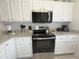 Clean kitchen with stainless steel appliances and granite countertops at 8545 Bay Lilly Loop, Kissimmee, FL 34747