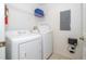 Convenient laundry room with washer, dryer, and shelving at 8545 Bay Lilly Loop, Kissimmee, FL 34747