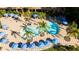 Relaxing pool area with numerous blue umbrellas and lounge chairs at 8545 Bay Lilly Loop, Kissimmee, FL 34747