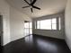 Bright, spacious bedroom featuring dark wood floors, a ceiling fan, and large windows at 300 New Waterford Pl # 204, Longwood, FL 32779