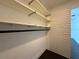 Walk-in closet featuring shelves, hanging rods, and a slatted wall at 300 New Waterford Pl # 204, Longwood, FL 32779