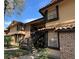 Exterior of condominium building featuring covered stairwell access and well-maintained landscaping at 300 New Waterford Pl # 204, Longwood, FL 32779