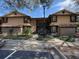 Attractive condominium complex with manicured landscaping, covered entry, and terra cotta tile roofing at 300 New Waterford Pl # 204, Longwood, FL 32779