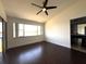 Light-filled main bedroom with hardwood floors and scenic lake views, plus an attached bathroom at 300 New Waterford Pl # 204, Longwood, FL 32779