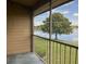 Enjoy serene lake views from this screened porch with verdant landscaping and beautiful light at 300 New Waterford Pl # 204, Longwood, FL 32779