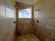 Shower featuring tiled walls and a glass window that allows natural light at 300 New Waterford Pl # 204, Longwood, FL 32779