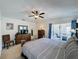 Bedroom with ceiling fan, outdoor access, and sitting area at 3075 Barbados Ln, Haines City, FL 33844