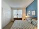 Bedroom featuring light blue accent wall, natural light, and neutral carpet at 3075 Barbados Ln, Haines City, FL 33844