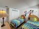 bedroom featuring twin beds and playful wall decor at 3075 Barbados Ln, Haines City, FL 33844