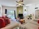 Spacious living room with large windows, comfortable seating, and view of the pool area at 3075 Barbados Ln, Haines City, FL 33844