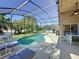 Inviting screened-in pool area with ample seating and lush greenery, perfect for outdoor relaxation at 3075 Barbados Ln, Haines City, FL 33844