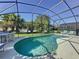 This screened-in pool area provides a serene backyard oasis with well-manicured landscaping and lounging areas at 3075 Barbados Ln, Haines City, FL 33844