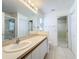 Bathroom showcasing a wide vanity, full mirror, and walk-in shower, providing a luxurious and open feel at 167 Bell Tower Xing W, Poinciana, FL 34759