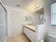 Bright bathroom featuring a spacious vanity, large mirror, and a well-lit shower area, offering comfort and functionality at 167 Bell Tower Xing W, Poinciana, FL 34759