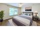 Bedroom features a large window, a bed, and gray furniture set on wooden floors at 167 Bell Tower Xing W, Poinciana, FL 34759