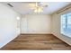 Bedroom features wooden floors, a ceiling fan and a large window at 167 Bell Tower Xing W, Poinciana, FL 34759